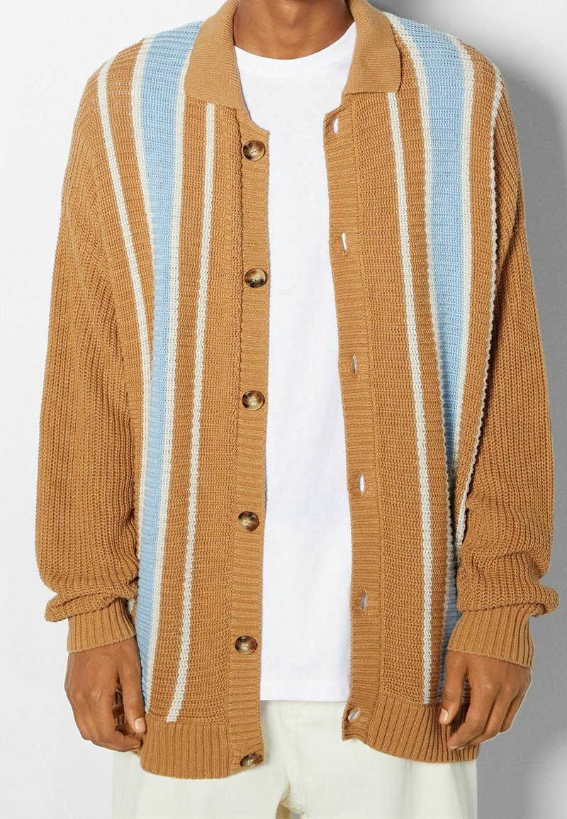 Brown striped cardigan with blue and white accents, textured knit material, button-up front, ribbed cuffs and hem.