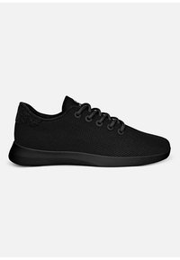 Black athletic shoes featuring a mesh upper, round laces, and a textured heel accent. The sole is solid black and slightly cushioned.