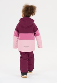 Paars en roze kleurblokjack met een capuchon, gecombineerd met bijpassende broeken. Het materiaal lijkt waterafstotend en heeft een soepele textuur.