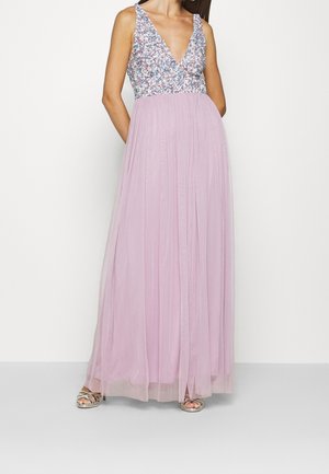 Woman wearing a sleeveless gown with a sequined floral bodice and a flowing light purple tulle skirt, paired with silver open-toe heels.