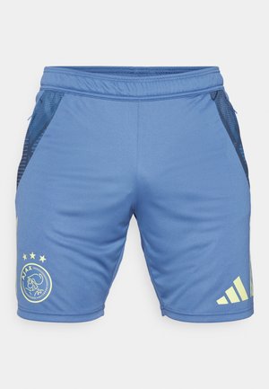 Blue athletic shorts made of smooth fabric with mesh side panels. Features a logo and stars in yellow on the front and branding on the side.