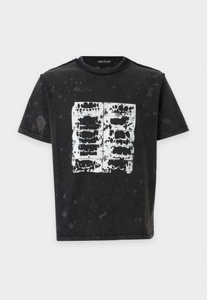 Black short-sleeve t-shirt with white abstract grid and teeth-like print on chest, featuring a faded, splattered pattern throughout the fabric.