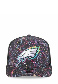 Casquette snapback noire avec un motif éclaboussé coloré ; présente un logo d'aigle brodé à l'avant ; design structuré et visière plate.