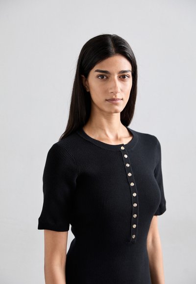 Black ribbed short-sleeve dress with a round neckline and a front button placket featuring metallic buttons. Smooth texture and fitted design.