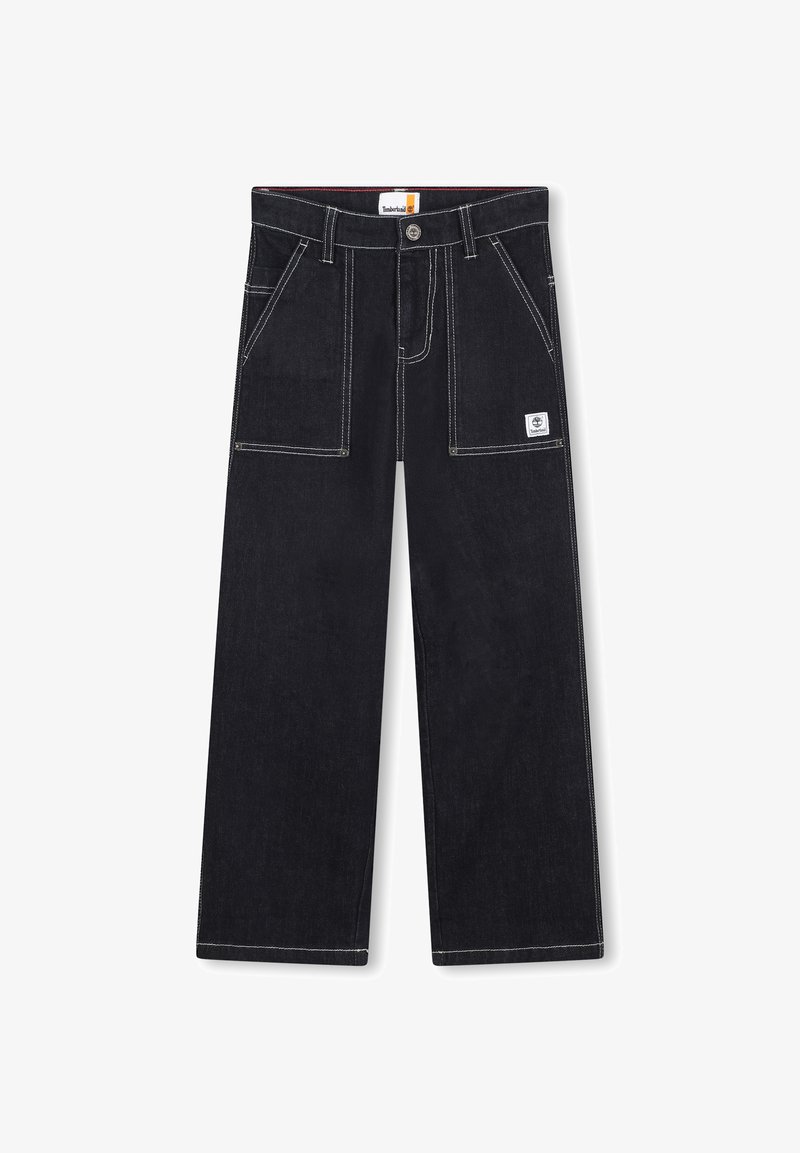 Pantalon en denim noir à coupe ample, avec des coutures blanches, de grandes poches avant et une étiquette logo sur la poche droite.