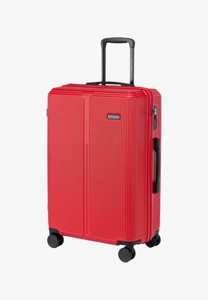 Czerwona walizka ze sztywnego materiału z pionowymi rowkami, czarną teleskopową rączką, czterema czarnymi kółkami oraz zamkiem szyfrowym. Logo marki z przodu.