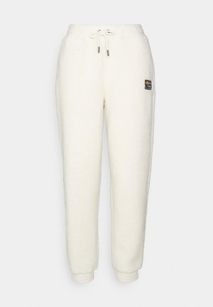 Fleece-Jogginghosen in Off-White mit tailliertem Schnitt, elastischem Bund mit Kordelzug und einem kleinen Markenpatch an der linken Hüfte.