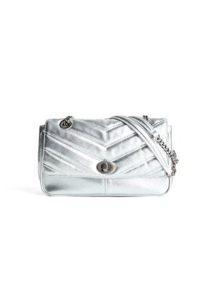 Metallic silver quilted shoulder bag with chevron stitching, silver turn-lock clasp, and chain-link strap.