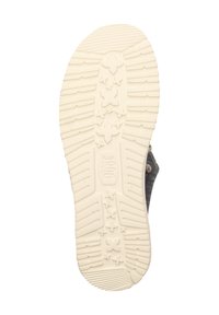 Sole della scarpa con un fondo in gomma bianca textured caratterizzato da scanalature lineari e motivi a stella, progettato per offrire aderenza e durabilità.