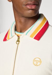 Sergio Tacchini SLICE TRACK JACKET - Veste de survêtement - gardenia/gold