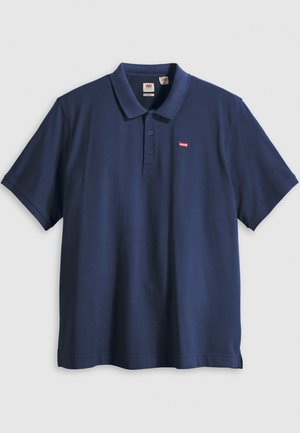 Navy blue polo shirt made of smooth cotton fabric, featuring a classic collar, three button placket, and a small red brand logo on the chest.