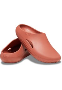 Pink rubber clogs with a smooth surface, rounded toe, backless design, and ventilation holes. Features textured sole for grip.