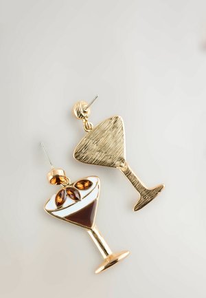 Gold-tone earrings shaped like cocktail glasses, featuring a white and brown enamel design with brown gem accents, exhibiting a textured finish.