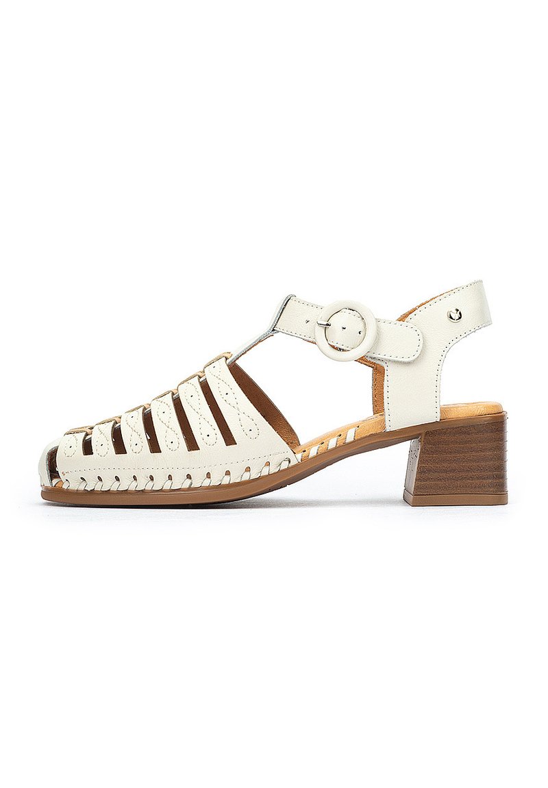 White leather sandal with cut-out design, adjustable ankle strap, and a brown block heel. Outsole has stitching detail and a rounded toe.