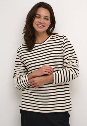 Striped long-sleeve top in cream and black, featuring a round neckline and ribbed texture, with cuffs and a relaxed fit.