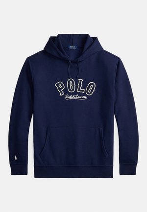 Tamsiai mėlynas džemperis su gaubtu, priekyje kišenė, raišteliai ir baltas užrašas „POLO Ralph Lauren“ ant krūtinės, taip pat mažas logotipas ant kairės rankovės krašto.
