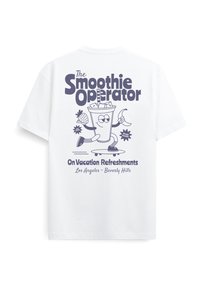 Λευκό μπλουζάκι με καρτούν ποτήρι smoothie που κρατάει φράουλα και μπανάνα, κάνει σκέιτμπορντ, και κείμενο "The Smoothie Operator" και "On Vacation Refreshments."