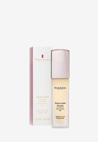 Fond de teint Fini Parfait dans un flacon en verre transparent avec un capuchon rose doré métallique. La boîte présente un fond blanc avec du texte et un logo rouges. 30 mL.