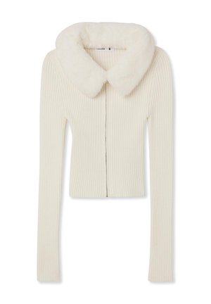 Cardigan a coste crema con colletto in pelliccia sintetica, zip frontale e maniche lunghe. Tessuto liscio con un design aderente.