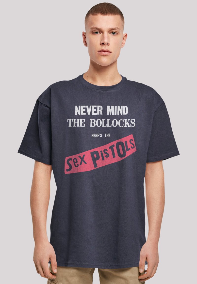 Navy blue t-shirt made of cotton featuring white and red printed text reading "Never Mind the Bollocks Here's the Sex Pistols."