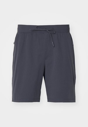 Pantaloni corti grigio scuro con cintura elastica e cordino. Tessuto morbido, due tasche laterali e design alla lunghezza del ginocchio. Senza motivi visibili.