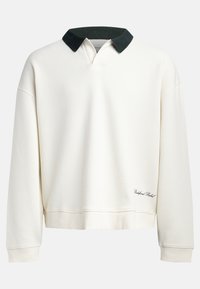 Crew-neck pullover in off-white cotton with a contrasting dark green collar. Features ribbed texture and embroidered logo near the hem.