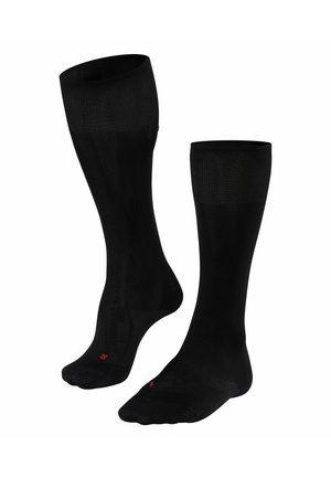 Schwarze knielange Socken mit glatter Textur, geripptem Oberteil und einem kleinen roten Logo am Fuß. Entwickelt für Komfort und Langlebigkeit.