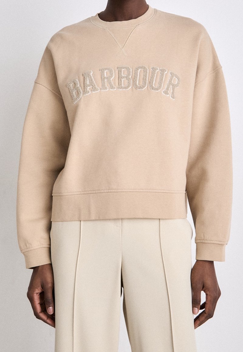 Beige sweatshirt with "BARBOUR" embroidered in a slightly darker thread, featuring a crew neck and a relaxed fit with ribbed cuffs.