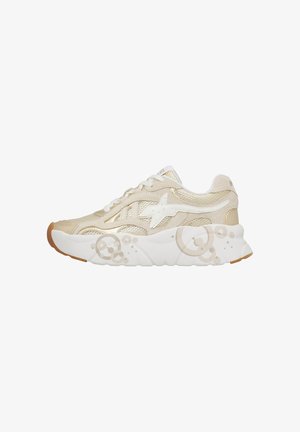 Beige and white sneaker with mesh panels, star logo on side, white laces, and thick sole featuring circular bubble patterns.
