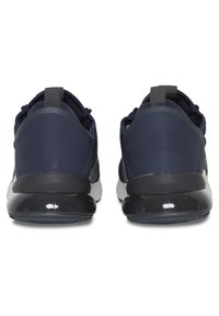 Navy athletic shoes with a smooth synthetic heel, mesh upper, and thick black rubber sole. Features a pull tab at the heel for easy wear.
