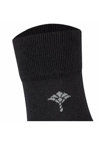 Svart socka med ribbad textur; har ett ljusgrått logomönster på sidan; elastisk mudd för en säker passform högst upp.