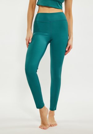 Teal high-waisted leggings gemaakt van een gladde, rekbare stof. Strak ontwerp met een zachte afwerking en platte naden. Geen zichtbare patronen of accenten.