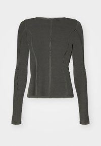 Long-sleeve top in dark green ribbed fabric. Features fitted design with visible seams and unique texture along the sleeves and body.
