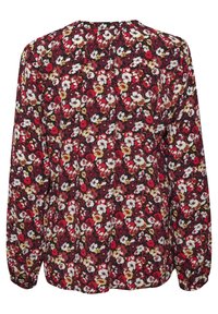 Långärmad blus i mörkröd med blommönster som har vita, gula och rosa blommor. Lättviktig tyg med en mjuk struktur.