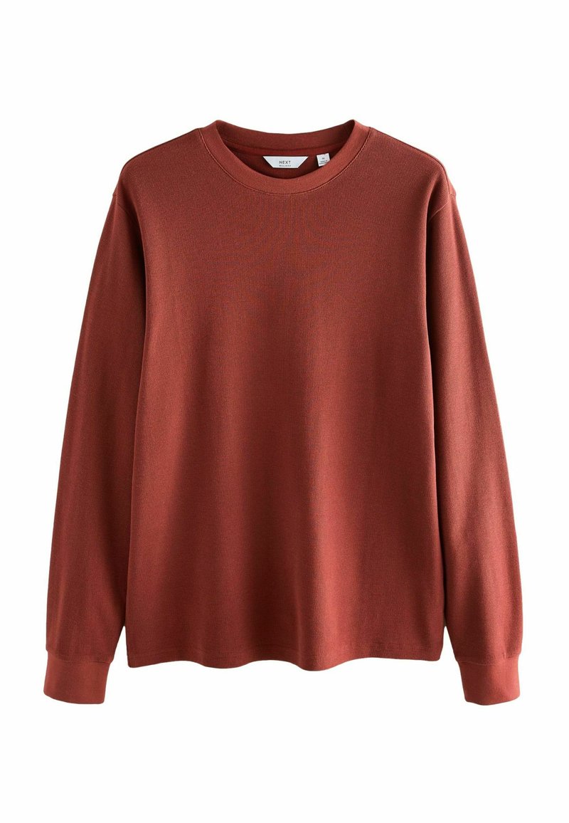 Rustfarvet sweatshirt med lange ærmer, tekstureret mønster, ribbet halsudskæring og manchetter. Lavet af blødt, strækbart materiale for komfort.