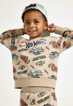 Béžová mikina s barevnými potisky aut, obsahující žebrované manžety a výstřih. Logo „Hot Wheels“ je výrazně umístěno na přední straně.