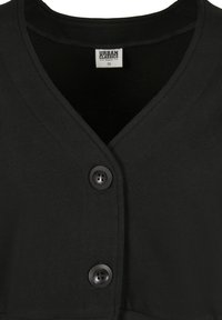 Svart V-hals cardigan med to svarte knapper og synlig Urban Classics Organic XS-merke inne i kragen.