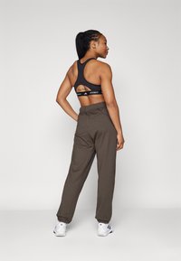 adidas Performance POWER LOOSE FIT - Treniņtērpa apakšdaļas - shadow olive