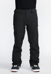 Black snowboarding pants made of durable fabric, featuring a relaxed fit, belt loops, pockets, and a small logo on the side.