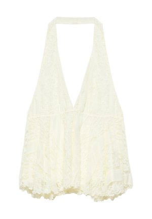 Hvid blonde haltertop med dyb V-udskæring og bølget kant, med fine blomstrede blonde mønstre over hele stoffet.