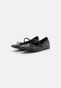 Black patent leather ballet flats with pointed toes, decorative front straps, and gathered accents along the edges. Flat soles.
