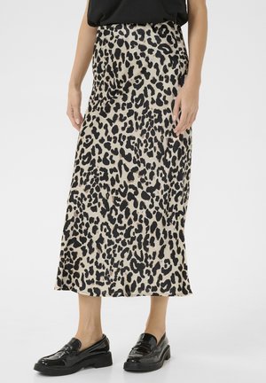 Falda midi de estampado de leopardo en una tela satinada con una cintura alta. La paleta de colores incluye beis, negro y sutiles manchas marrones. Mocasines negros completan el look.