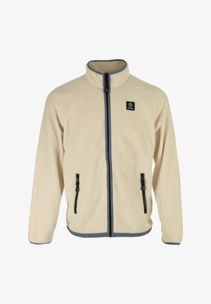 Beige fleece jas met hoge kraag, voorkant met ritssluiting en twee zijzakken. Heeft zwarte ritssluitingen en een blauwe bies langs de onderkant.