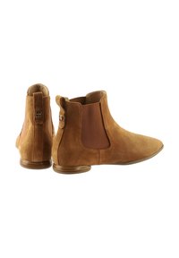 Brown suede Chelsea boots featuring elastic side panels and a smooth rounded toe. Compact design with a low stacked heel.