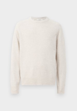 Cream-colored sweater featuring a round neckline, ribbed cuffs, and hem. Soft texture with a simple, clean design and raglan sleeves.