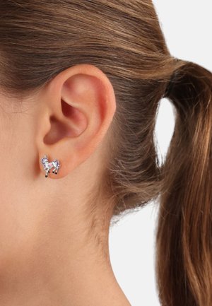 Einhorn-Piercings aus Metall mit bunten Emaille-Akzenten. Verfügt über einen weißen Körper, eine lila Mähne und schwarze Beine auf einem hellen Hintergrund.