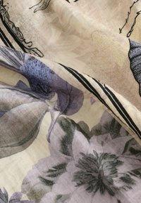 Floral scarf in soft fabric, featuring purple and green flowers on a light cream background, with fine black outlines and detailed textures.