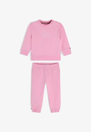 Sweat-shirt rose clair à manches longues et pantalon de jogging assorti avec poignets en côtes, taille élastique et petits détails avec logo.