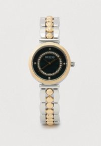 Sat za ručni zlatne i srebrne boje od nehrđajućeg čelika s okruglim crnim brojčanikom, kristalnim okvirom i povezanim ukrasima. Ima zlatne detalje i crne kazaljke.