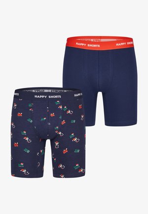 Twee paar herenboxers: één effen marineblauw met een rode tailleband, de andere met een patroon van feestelijke ontwerpen in groen, rood en wit.